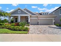 Beautiful single-Gathering home featuring a well-manicured front yard, two-car garage, and charming architectural details at 7520 Paradiso Dr, Apollo Beach, FL 33572