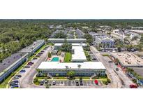 Wonderful aerial view of complex with a swimming pool and well manicured landscaping at 1433 S Belcher Rd # B11, Clearwater, FL 33764
