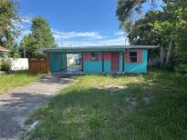 A colorful one-story home with a covered carport and small front yard at 1504 Stevensons Dr, Clearwater, FL 33755