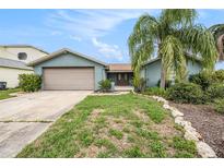 Charming single-story home featuring a well-manicured lawn and inviting curb appeal at 15525 Old Dixie Hwy, Hudson, FL 34667
