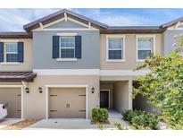 Charming two-story townhome with a one car garage and welcoming front entrance at 17482 Nectar Flume Dr, Land O Lakes, FL 34638