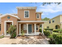 Charming two-story home with a well-manicured lawn, covered porch and attractive landscaping at 2570 Sea Wind Way, Clearwater, FL 33763