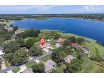 Stunning aerial view of lakeside home with lush greenery and scenic surroundings at 271 Eastpoint Ct, Spring Hill, FL 34606