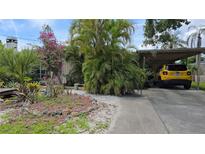 Lush front yard with tropical plants and charming decorative elements enhances curb appeal at 3261 Mayflower St, Sarasota, FL 34231