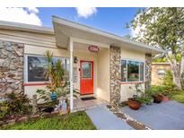 Charming home exterior showcasing stone accents and a vibrant red front door with a 