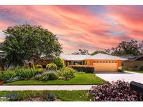 Charming single-story home featuring a lush, landscaped front yard and a two-car garage at 104 Foxwood Dr, Brandon, FL 33510