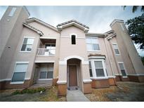 Charming condo with stucco exterior, balcony and tiled roof, offering a desirable curb appeal at 10409 Villa View Cir # 10409, Tampa, FL 33647