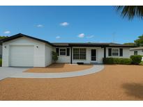 Charming single-story home with neutral exterior, attached garage and well-maintained landscaping at 10914 Oakdale Ave, Port Richey, FL 34668