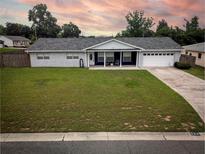 Charming single story home featuring manicured lawn, stone details, attached garage, and a covered front porch at 123 Jeffrey Dr, Brandon, FL 33511