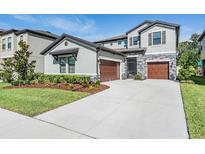Beautiful two-story home with two-car garage, well-maintained lawn, and stone accents at 14626 Horse Trot Rd, Lithia, FL 33547