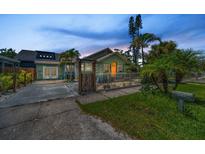 Charming bungalow home featuring lush landscaping, quaint fencing, and a welcoming walkway to the main entrance at 1801 52Nd S St, Gulfport, FL 33707