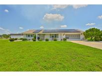 Charming single-story home with well-manicured lawn and solar panels at 1811 Milford Cir, Sun City Center, FL 33573