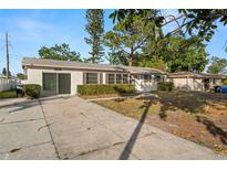 Charming single-story home with a well-manicured front yard and mature trees, providing curb appeal at 2145 68 S Ave, St Petersburg, FL 33712