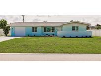 Charming single-story home featuring a well-manicured lawn and an attached one car garage at 3316 Port Charlotte Blvd, Port Charlotte, FL 33952