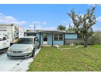 Charming single-story home featuring a well-manicured lawn and a welcoming front porch area at 2149 Dixie Garden Loop, Holiday, FL 34690