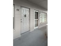 Apartment entryway featuring two doors with unit numbers and a neutral color scheme at 2460 Persian Dr # 44, Clearwater, FL 33763