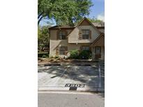 Charming two-story condo featuring neutral stucco, shuttered windows and reserved parking at 3902 Brigadoon Cir, Clearwater, FL 33759