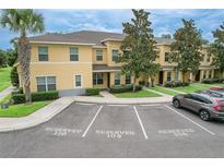 Inviting two-story townhome featuring reserved parking, well-manicured landscaping, and a welcoming entrance at 6332 Timberly Ln, Zephyrhills, FL 33542