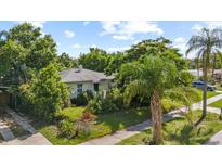 Charming single-story home with lush landscaping and mature trees in a serene setting at 1222 Palm St, Clearwater, FL 33755