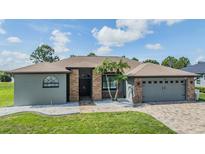Charming single-story home featuring a brick facade, two-car garage, and well-maintained landscaping at 12910 Prestwick Dr, Riverview, FL 33579