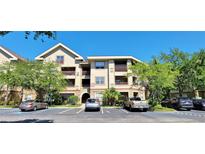 Attractive condominium building with assigned parking and mature landscaping at 16501 Harper Pond Ln # 308, Odessa, FL 33556