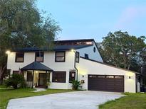 Charming two-story home with a well-manicured lawn, updated garage, and cozy covered entryway at 17926 Calkins Ct, Spring Hill, FL 34610
