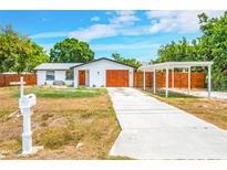 Charming single Gathering home boasts a private carport and well-maintained front yard at 208 Palmetto W Rd, Nokomis, FL 34275