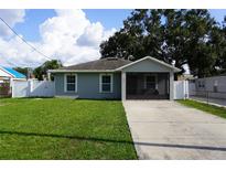 Charming single-story home featuring a well-maintained lawn and a screened front porch at 2304 W Rio Vista Ave, Tampa, FL 33603