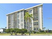Multi-story condo building featuring balconies and well-maintained landscaping at 400 Island Way # 1606, Clearwater Beach, FL 33767
