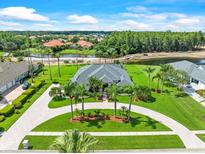 Stunning home boasts lush landscaping, circular driveway, and serene water views in a desirable community at 4521 Cheval Blvd, Lutz, FL 33558