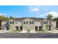 New townhomes with attached garages and manicured landscaping offer comfortable living at 17491 Spanish Oak Loop, Land O Lakes, FL 34638
