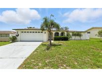 Charming single-story home with a well-manicured lawn and attached two car garage at 3633 Odom Dr, New Port Richey, FL 34652
