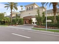 Arbor Place City Homes entrance showcasing tropical landscaping and an elegant covered entry at 501 Knights Run Ave # 2218, Tampa, FL 33602