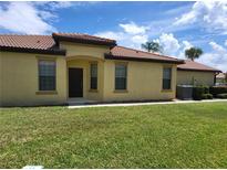 Charming single-story home featuring a well-manicured lawn and a welcoming entrance with a tiled roof at 5473 Sunset Falls Dr, Apollo Beach, FL 33572