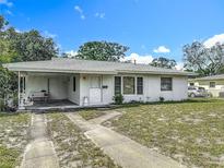 Charming single-story home featuring a covered porch and well-maintained front yard and driveway at 6832 Treehaven Dr, Spring Hill, FL 34606