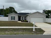 Charming single-story home with a well-manicured lawn and a two-car garage at 9397 Northcliffe Blvd, Spring Hill, FL 34606
