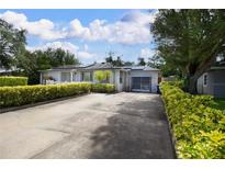 Charming single-story home with well-maintained landscaping, featuring a long driveway and attached garage at 101 N Corona Ave, Clearwater, FL 33765
