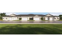 Charming townhomes feature attached garages and manicured landscaping at 10953 Teal Lagoon Isle, San Antonio, FL 33576