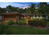Charming home featuring a brick exterior, well-manicured landscaping, and a welcoming entrance at 11279 Oakridge Trl, Seminole, FL 33772