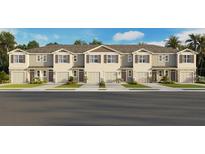 Charming townhome exterior featuring stone accents, a private garage, and manicured landscaping at 2466 Riversong Lodge Ln, Wesley Chapel, FL 33543
