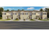 Attractive townhome exterior featuring a well-maintained facade, attached garages, and manicured landscaping at 2476 Riversong Lodge Ln, Wesley Chapel, FL 33543
