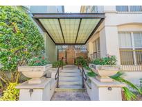 Inviting entryway with an attractive awning, manicured landscaping, and tiled stairs leading to the building's entrance at 501 S Moody Ave # 1134, Tampa, FL 33609