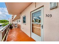 Condo 303 features a welcoming entry with orange flooring and a decorative wreath on the door at 5623 80Th N St # 303, St Petersburg, FL 33709