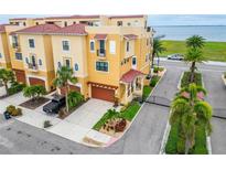 Beautiful yellow townhouses feature red tile roofs and meticulously maintained landscaping at 6412 Mayra Shores Ln, Apollo Beach, FL 33572