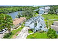 Beautiful two-story home featuring a modern design, lush landscaping, and ample parking at 8759 Orient Ne Way, St Petersburg, FL 33702