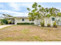 Charming single-story home featuring mature palm trees, and a covered carport at 4362 Wesley Ln, North Port, FL 34287