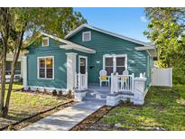 Charming teal bungalow with a quaint front porch and landscaped walkway at 4820 8Th S Ave, St Petersburg, FL 33711