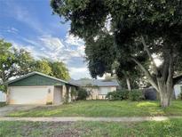 Charming single-story home with a front yard and attached garage at 9578 121St St, Seminole, FL 33772