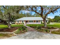 Beautiful brick home with manicured landscaping, brick walkway and a charming white picket fence at 11301 Donneymoor Dr, Riverview, FL 33569