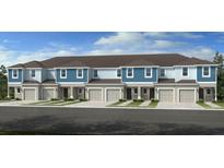 Attractive townhome with blue and light-blue color scheme, two stories, and individual garages at 13236 Stable Pl, Parrish, FL 34219